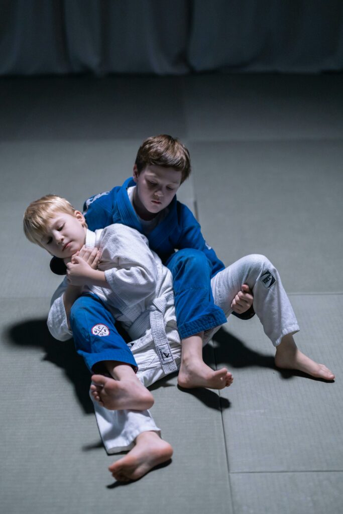 pexels-photo-7988828-7988828-1 Two young boys practicing judo on mats, showcasing martial arts skills and discipline.
