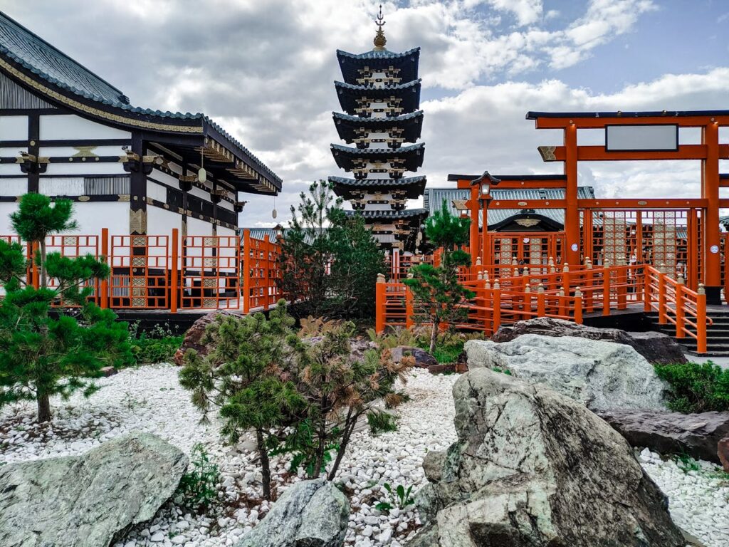 pexels-photo-9536301 A picturesque view of a traditional Japanese pagoda surrounded by a tranquil garden with rocks and greenery.